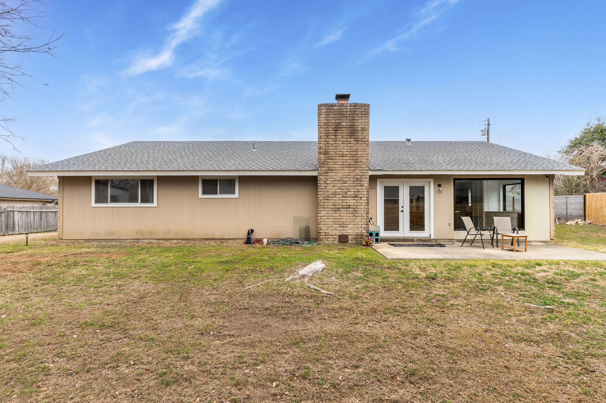612 Meadowbrook Drive Georgetown, TX 78628 - Photo 31 of 35 Rear view of property with french doors, a shingled roof, a chimney, and a patio area