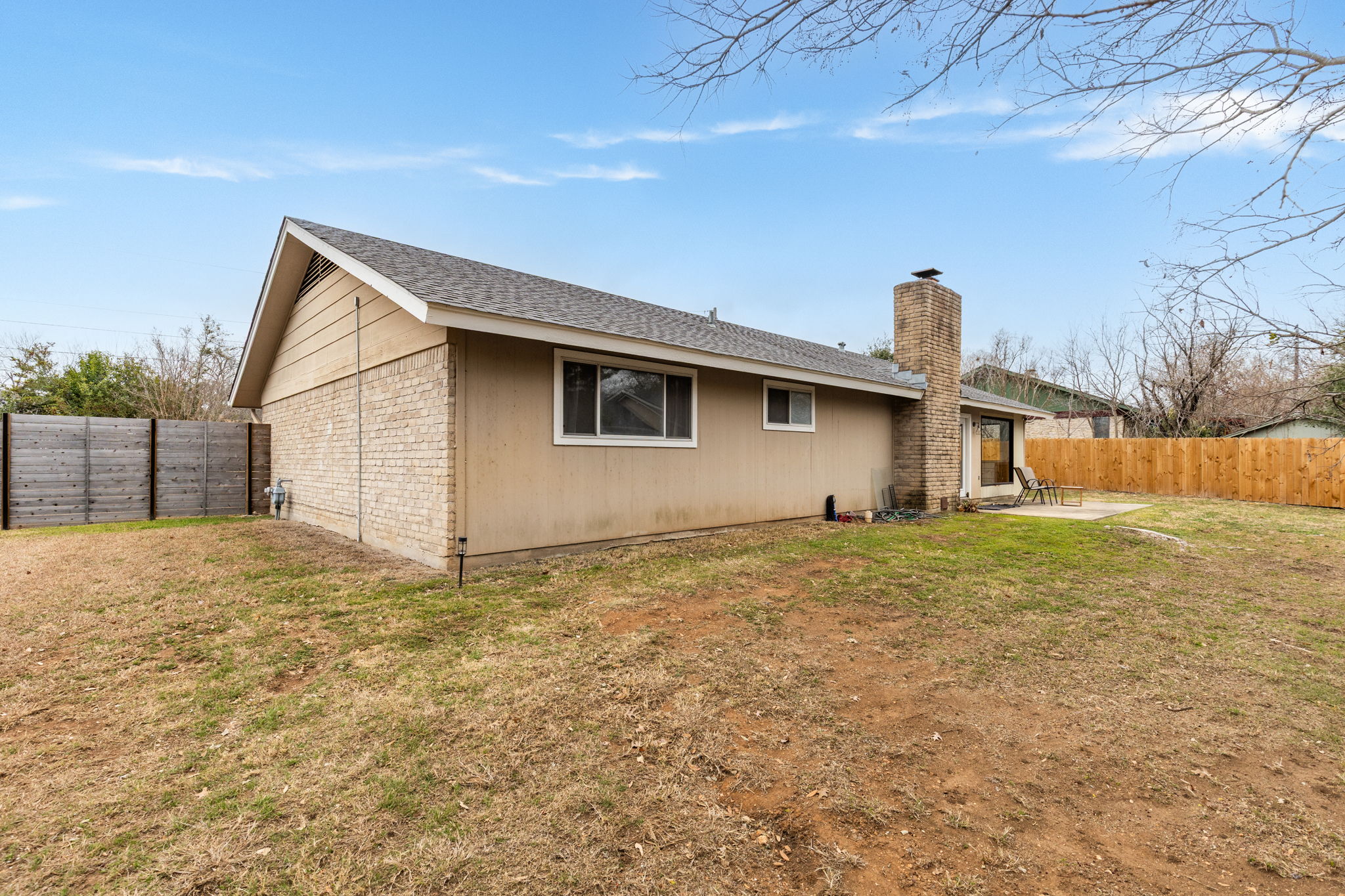 612 Meadowbrook Drive Georgetown, TX 78628 - Photo 32 of 35 Rear view of property featuring a fenced backyard, a patio area, a chimney, and brick siding