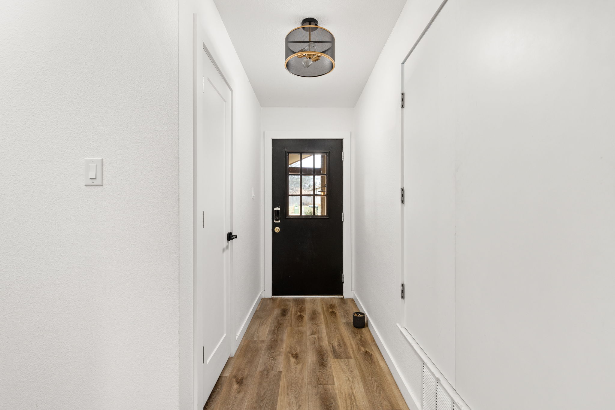 612 Meadowbrook Drive Georgetown, TX 78628 - Photo 6 of 35 Doorway to outside featuring wood finished floors and baseboards