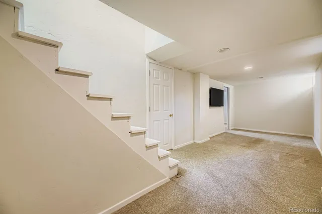 a view of an empty room with white walls