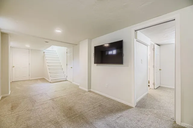 a view of a livingroom with an empty space & a flat screen tv
