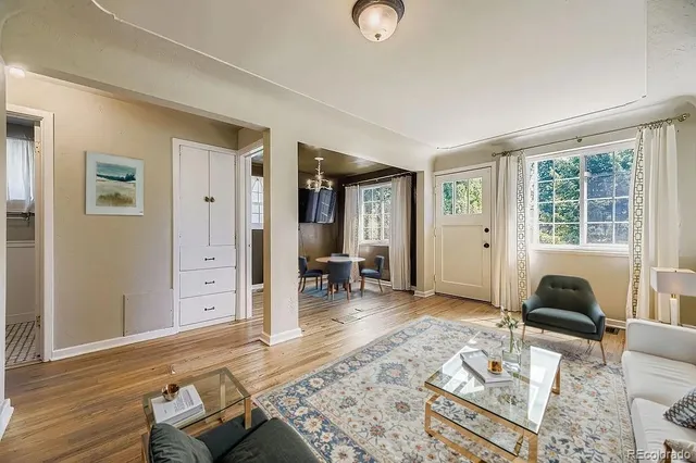 a living room with furniture and wooden floor