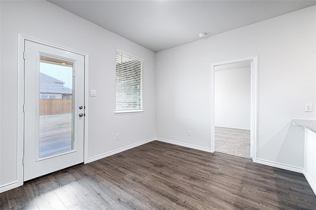 2427 Grapevine Way Celina, TX 75009 - Photo 20 of 38 an empty room with wooden floor and windows