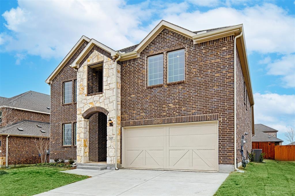 2427 Grapevine Way Celina, TX 75009 - Photo 2 of 38 a front view of a house with garden