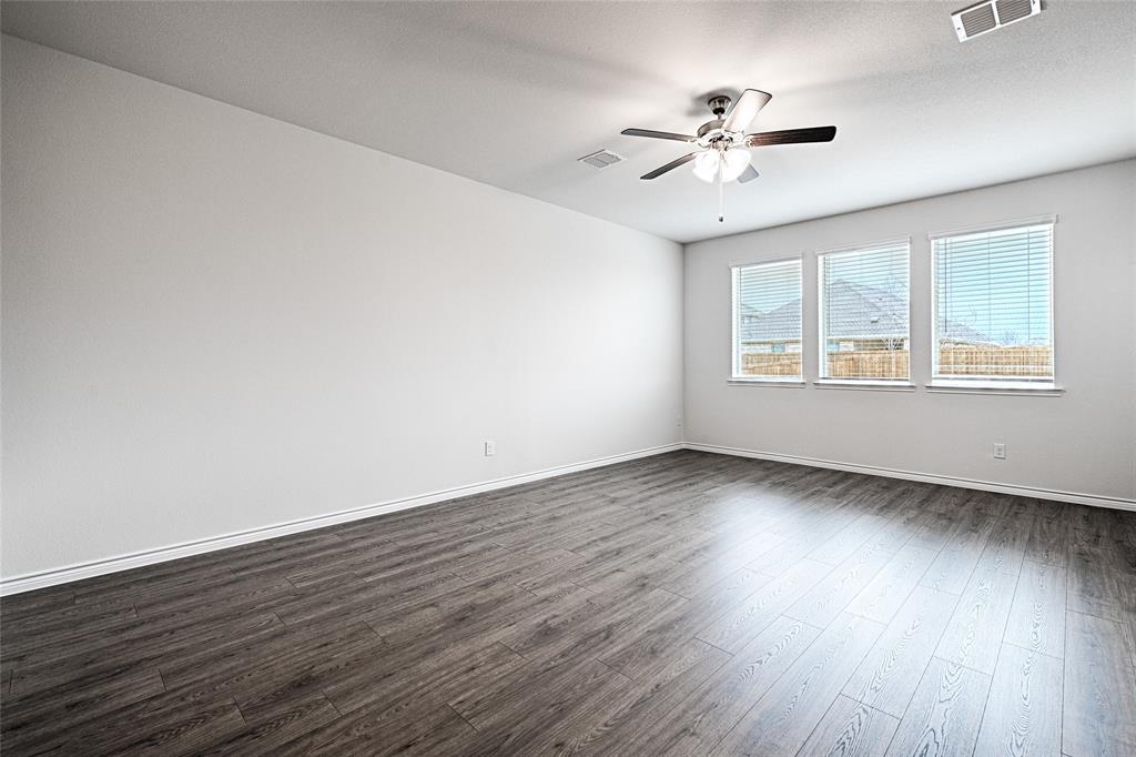 2427 Grapevine Way Celina, TX 75009 - Photo 22 of 38 an empty room with wooden floor window and ceiling fan