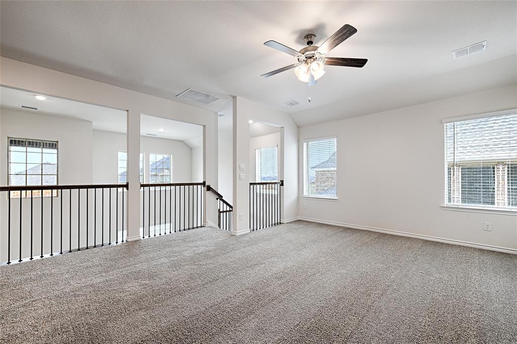 2427 Grapevine Way Celina, TX 75009 - Photo 23 of 38 an empty room with windows and ceiling fan