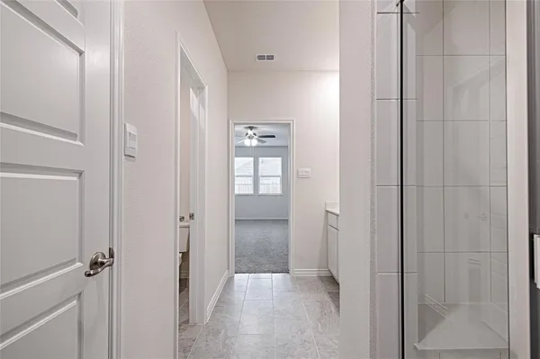 a view of a bathroom from a hallway