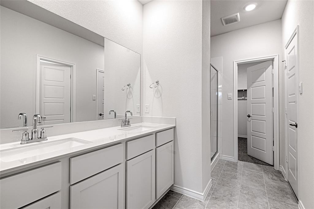 2427 Grapevine Way Celina, TX 75009 - Photo 27 of 38 a bathroom with a sink and a mirror