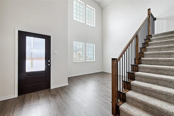 a view of an entryway with wooden floor and door