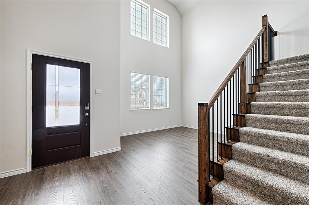 2427 Grapevine Way Celina, TX 75009 - Photo 5 of 38 a view of an entryway with wooden floor and door
