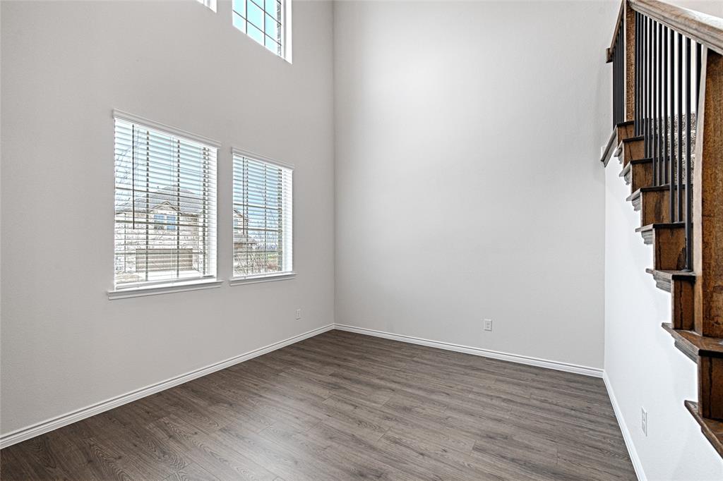 2427 Grapevine Way Celina, TX 75009 - Photo 8 of 38 wooden floor in an empty room with a window