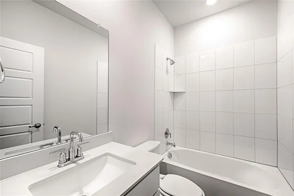 a bathroom with a sink toilet vanity and shower