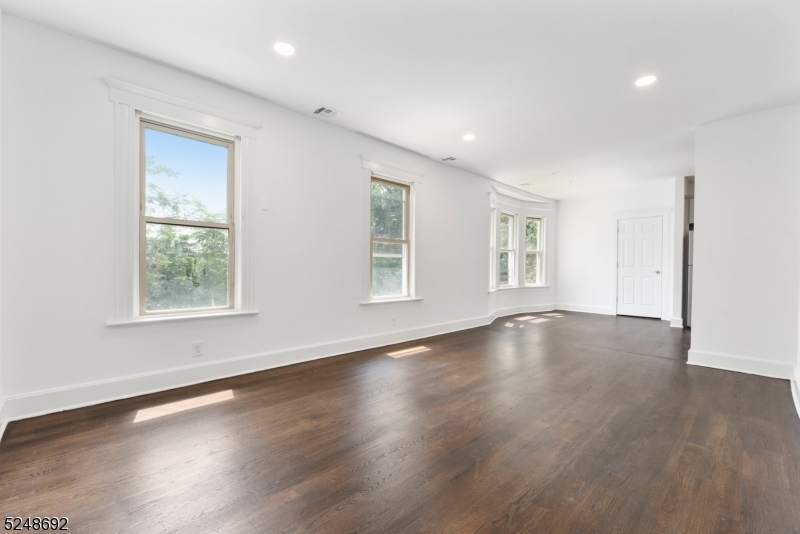 67 Dunnell Road, Unit 2 Maplewood, NJ 07040 - Photo 2 of 16 an empty room with wooden floor and windows