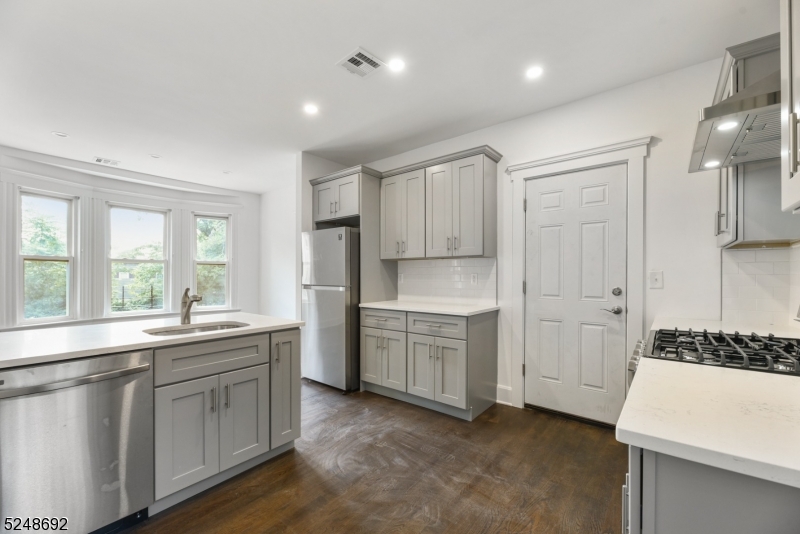 67 Dunnell Road, Unit 2 Maplewood, NJ 07040 - Photo 6 of 16 a kitchen with white cabinets and sink