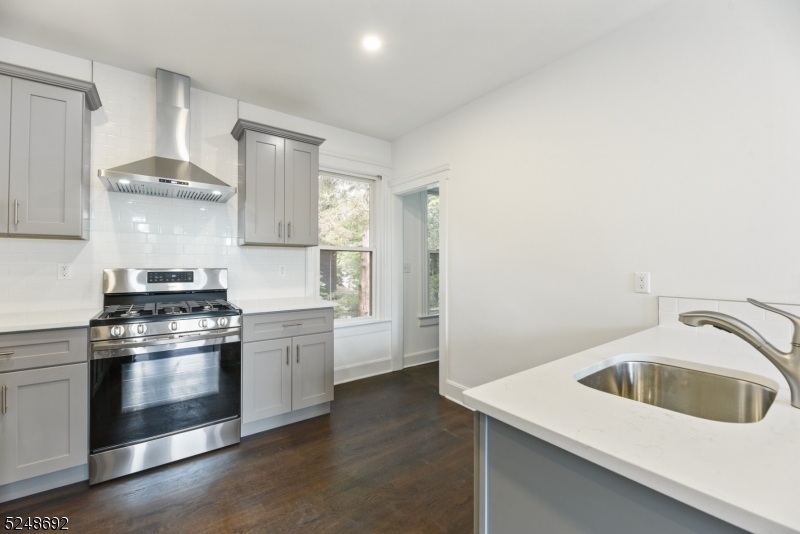67 Dunnell Road, Unit 2 Maplewood, NJ 07040 - Photo 7 of 16 a kitchen with a stove cabinets and wooden floor