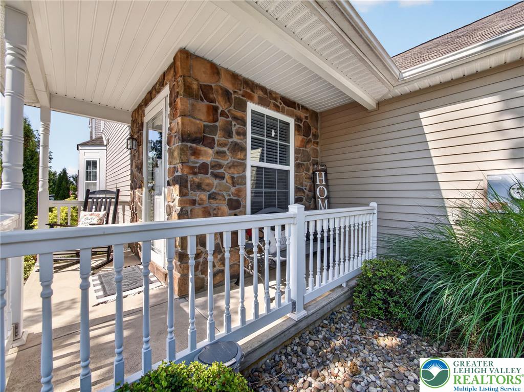 4148 Ross Road Bethlehem, PA 18020 - Photo 19 of 67 A welcoming covered porch with a stone facade offers a cozy spot for relaxation.