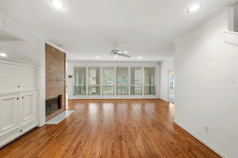 wooden floor in an empty room with a fireplace