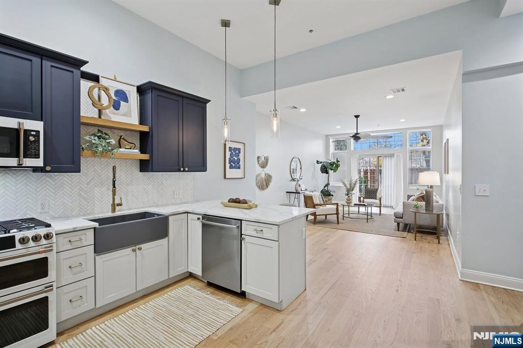 a kitchen with a sink stove and wooden floor