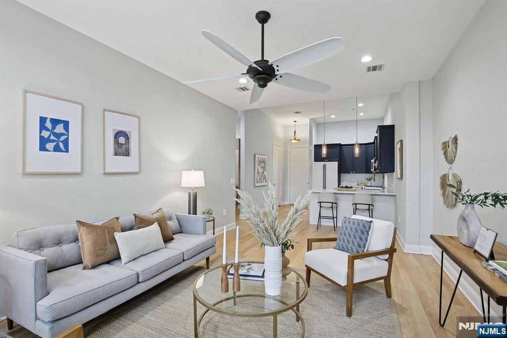 186 Walnut Street, Unit 114 Bloomfield, NJ 07003 - Photo 12 of 30 a living room with furniture kitchen view and a chandelier