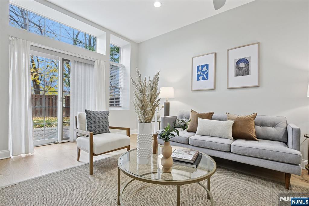 186 Walnut Street, Unit 114 Bloomfield, NJ 07003 - Photo 14 of 30 a living room with furniture and a large window