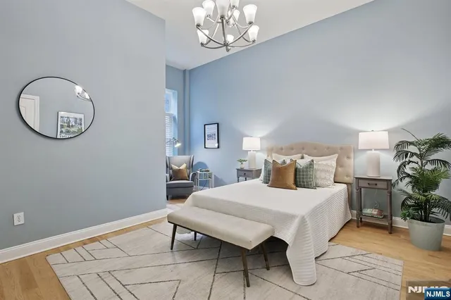 a bedroom with a bed and chandelier