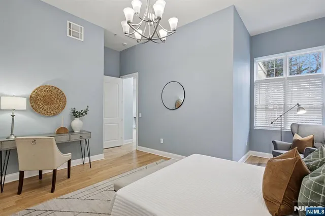a bedroom with a bed and a chandelier
