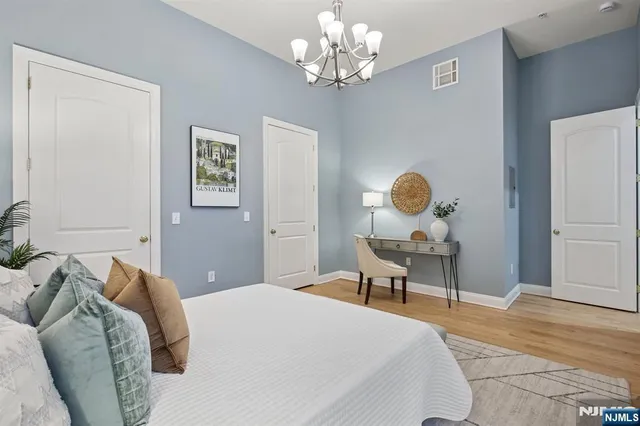 a bedroom with a bed and a chandelier