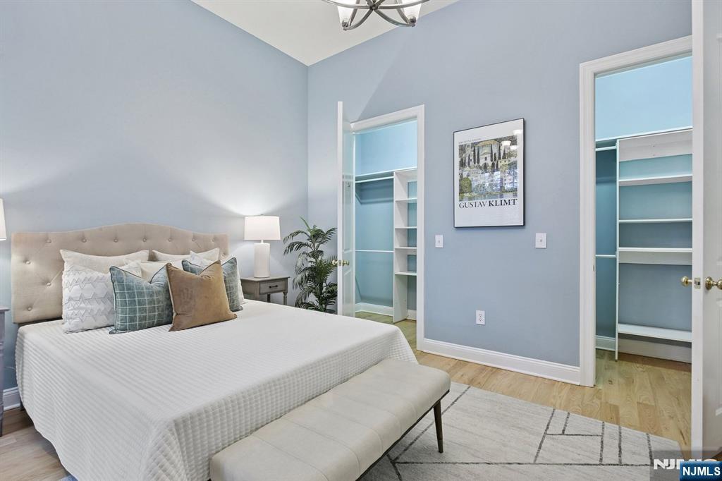 186 Walnut Street, Unit 114 Bloomfield, NJ 07003 - Photo 22 of 30 a bedroom with a bed and painting on the wall