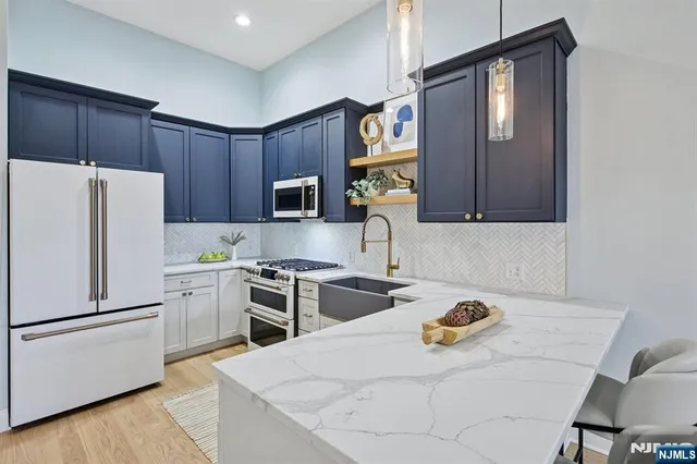 a kitchen with a refrigerator stove and microwave