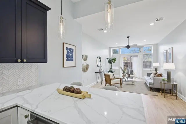 a living room with furniture and a chandelier