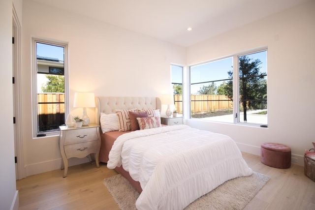 a bedroom with a bed and a large window