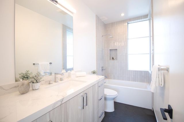 a kitchen with a sink appliances and cabinets