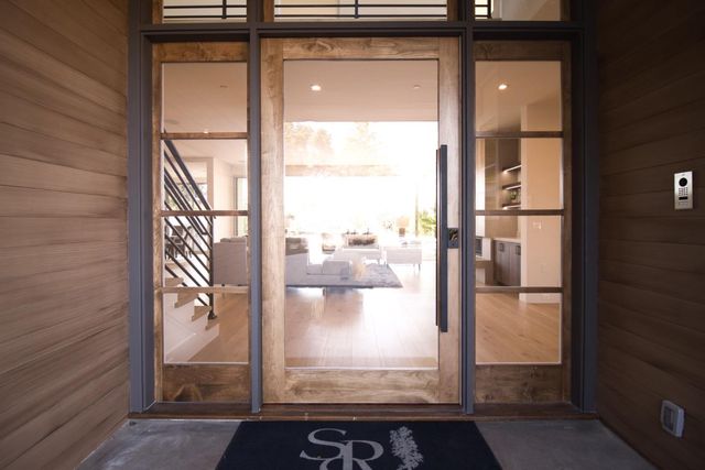 a living room with furniture wooden floor and a refrigerator