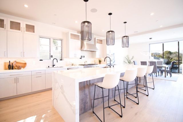 a kitchen with stainless steel appliances kitchen island granite countertop a sink and cabinets