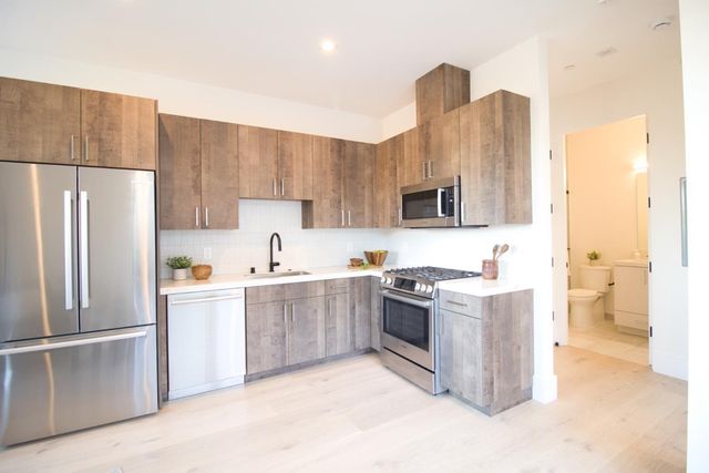 a kitchen with refrigerator cabinets and a counter top space