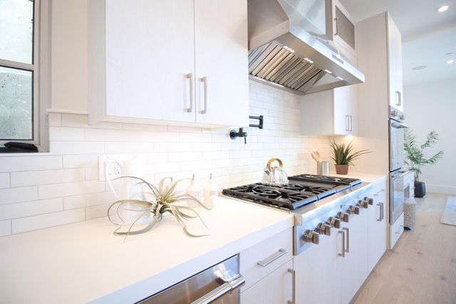 a kitchen with stainless steel appliances kitchen island granite countertop a sink and cabinets