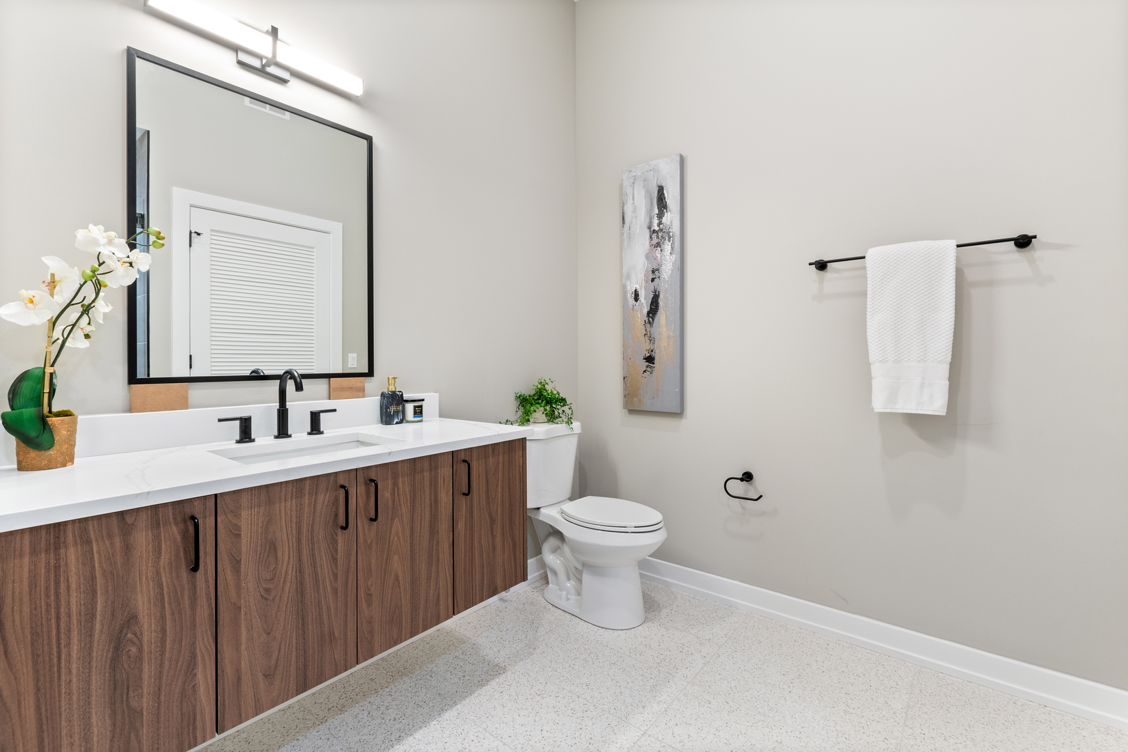 Undisclosed Address Chicago, IL 60657 - Photo 12 of 16 a bathroom with a toilet sink a mirror and vanity
