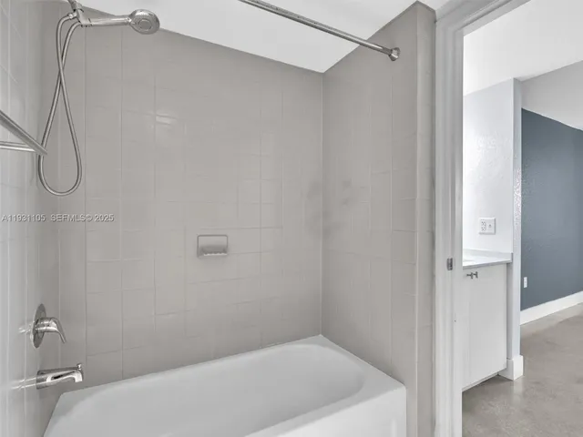 a kitchen with a sink a refrigerator and cabinets