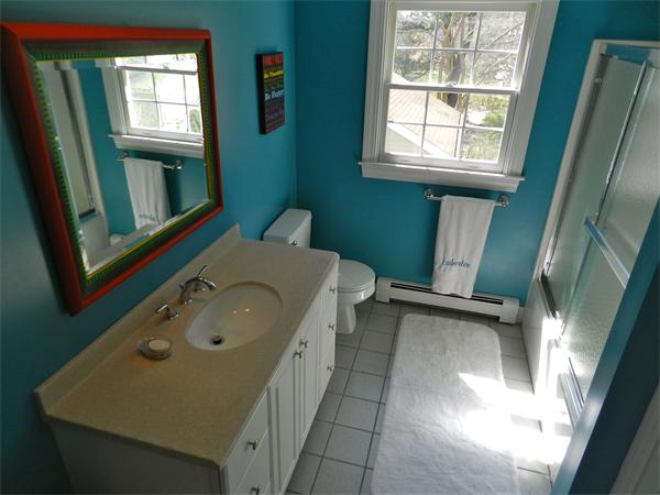 58 Pershing Road Boston, MA 02130 - Photo 18 of 30 a bathroom with a sink a toilet and tub