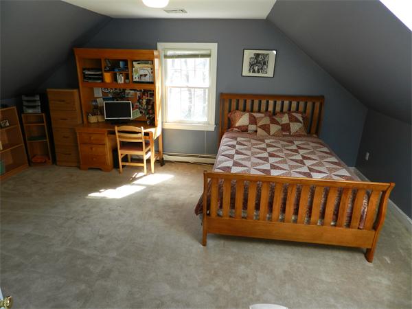 58 Pershing Road Boston, MA 02130 - Photo 20 of 30 a bedroom with a bed and a table in it