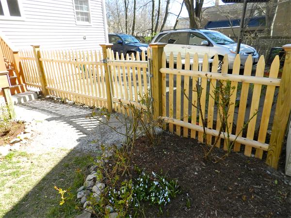 58 Pershing Road Boston, MA 02130 - Photo 27 of 30 a view of a house with a small yard and wooden fence