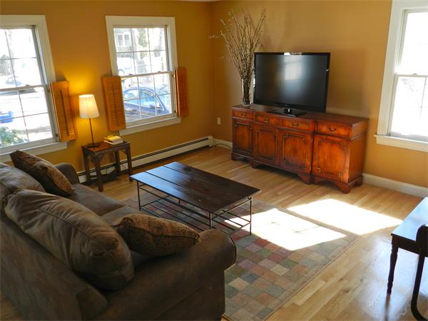 58 Pershing Road Boston, MA 02130 - Photo 4 of 30 a living room with furniture and a flat screen tv