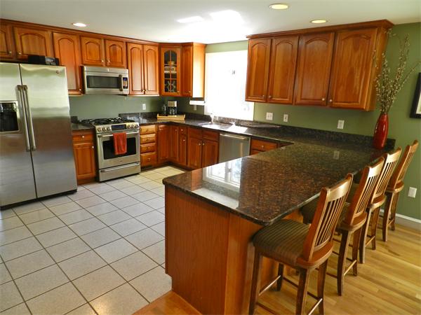58 Pershing Road Boston, MA 02130 - Photo 9 of 30 a kitchen with stainless steel appliances granite countertop a sink counter space and a window
