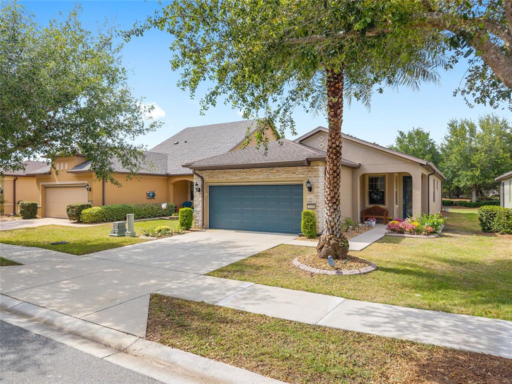 7676 Southwest 94th Circle Ocala, FL 34481 - Photo 1 of 45 a front view of a house with a yard and garage