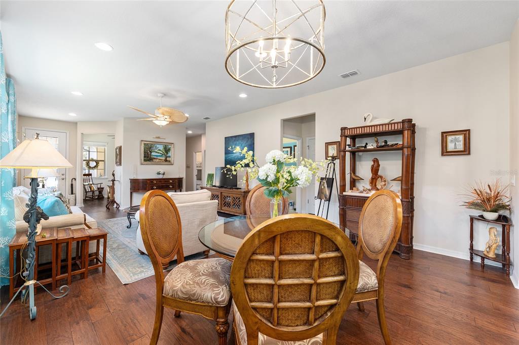 7676 Southwest 94th Circle Ocala, FL 34481 - Photo 17 of 45 a dining room with furniture a chandelier and wooden floor