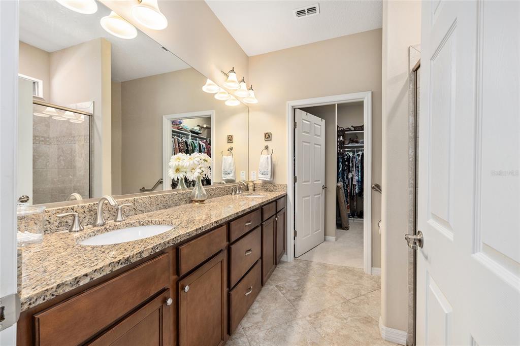 7676 Southwest 94th Circle Ocala, FL 34481 - Photo 23 of 45 a bathroom with a granite countertop sink mirror and a