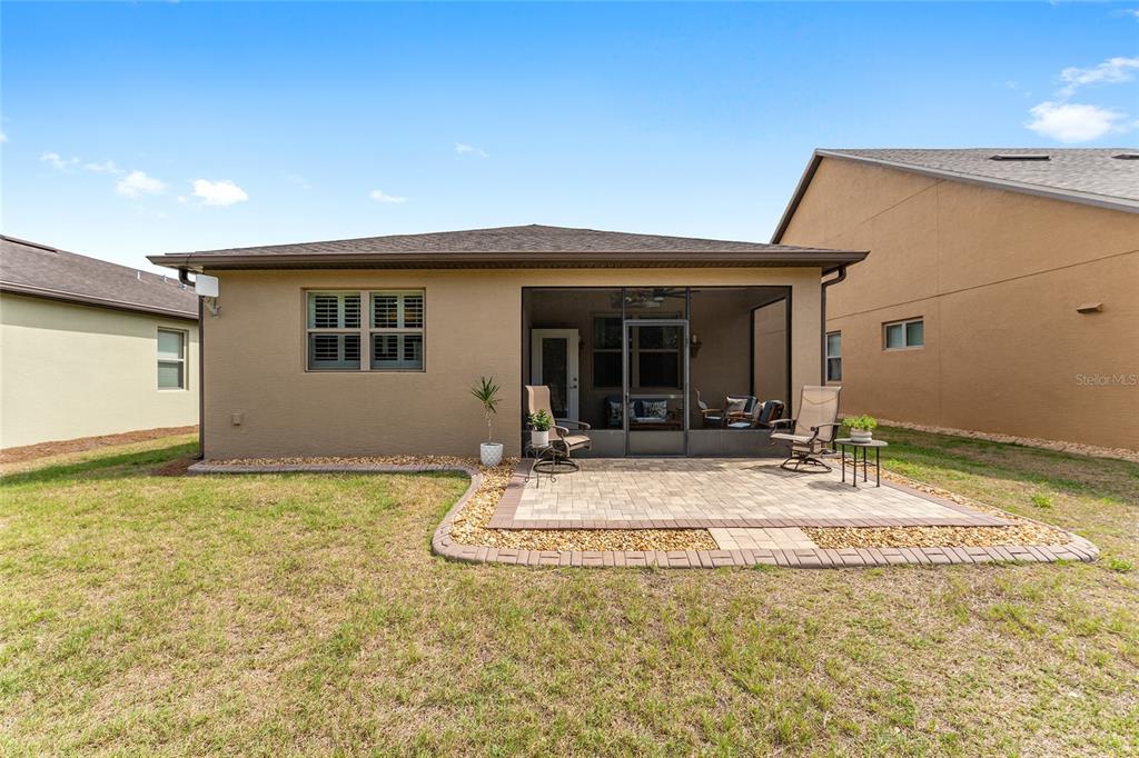 7676 Southwest 94th Circle Ocala, FL 34481 - Photo 36 of 45 a view of a house with table and chairs in patio