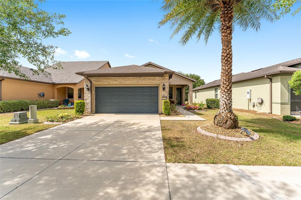 7676 Southwest 94th Circle Ocala, FL 34481 - Photo 38 of 45 a front view of a house with garden