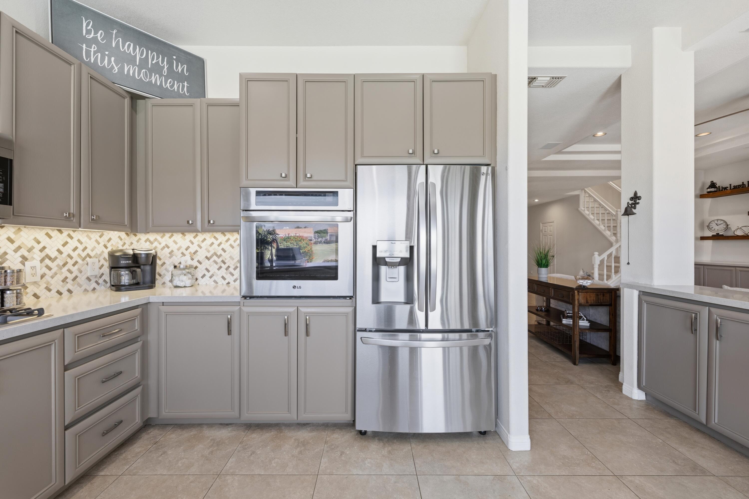 39 Augusta Drive Rancho Mirage, CA 92270 - Photo 19 of 53 a kitchen with cabinets and stainless steel appliances