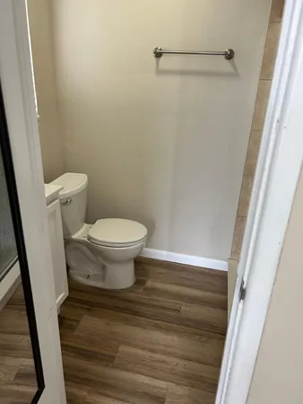 a bathroom with a toilet and a shower